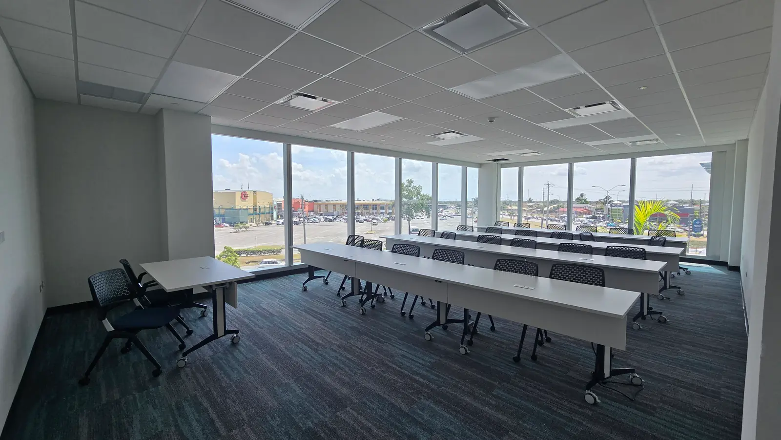 The same training room, furnished with desks and screens