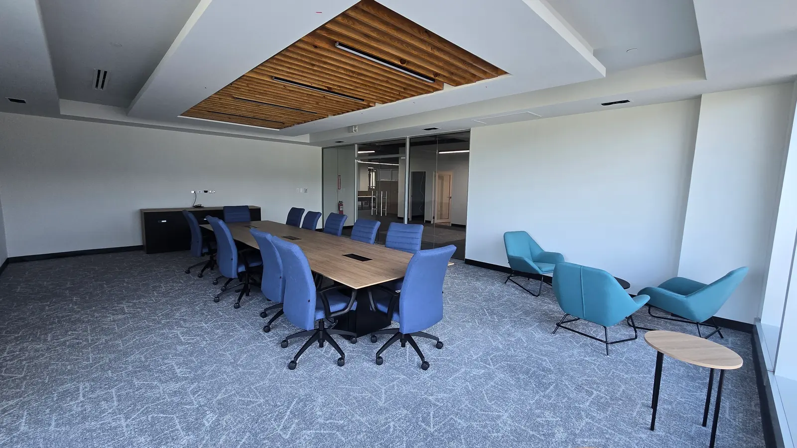 A boardroom with a long table and chairs