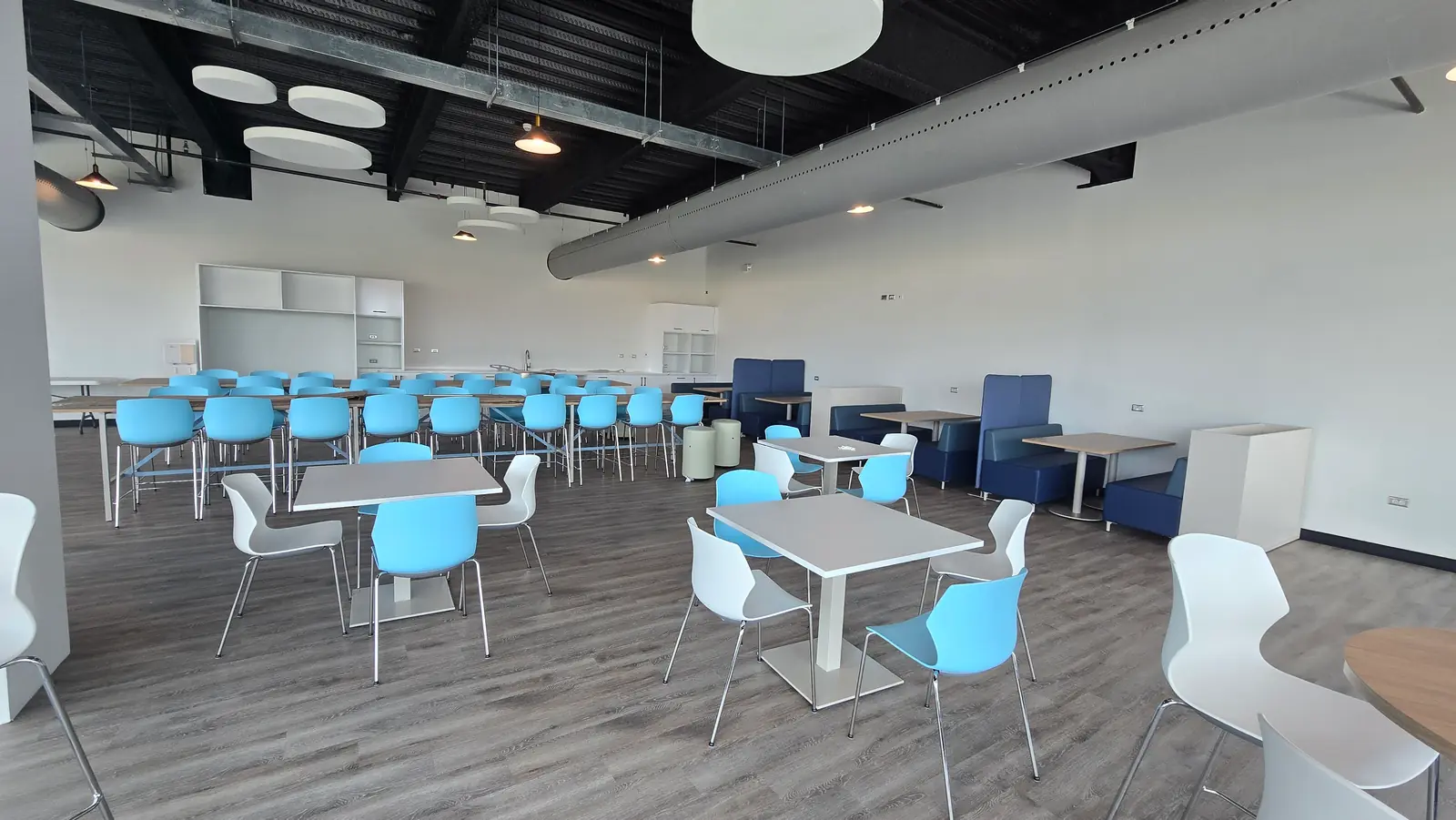 A staff cafe area with tables and seating