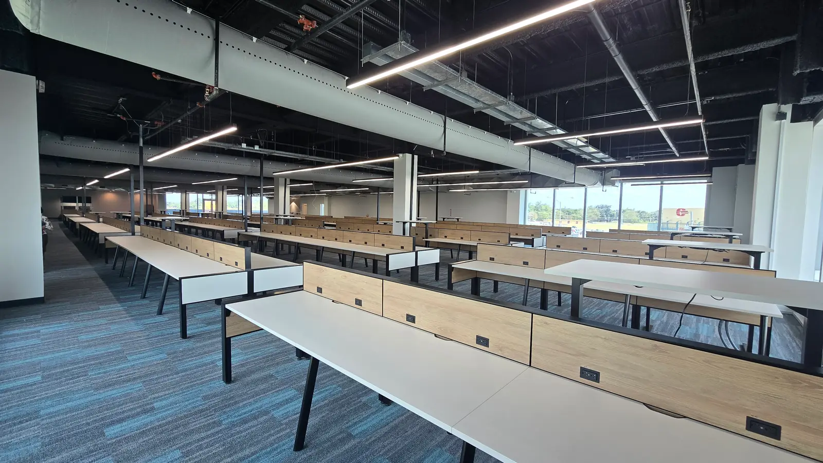 A large, newly fitted operations floor with rows of desks, in a facility developed within our group