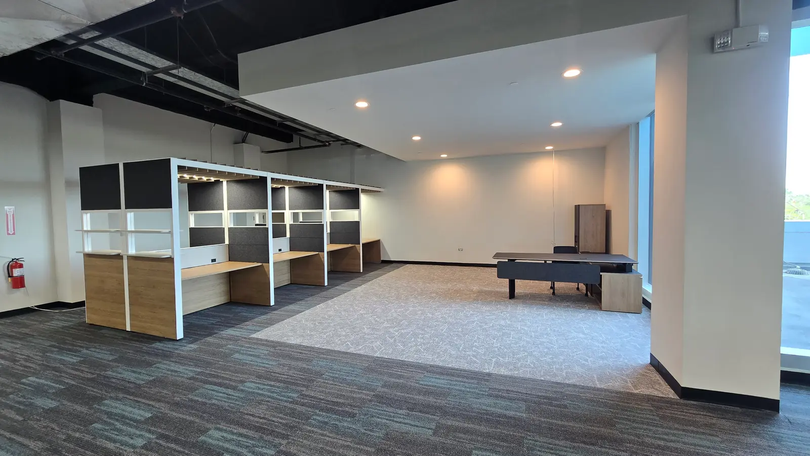 A room with a row of partitioned desks