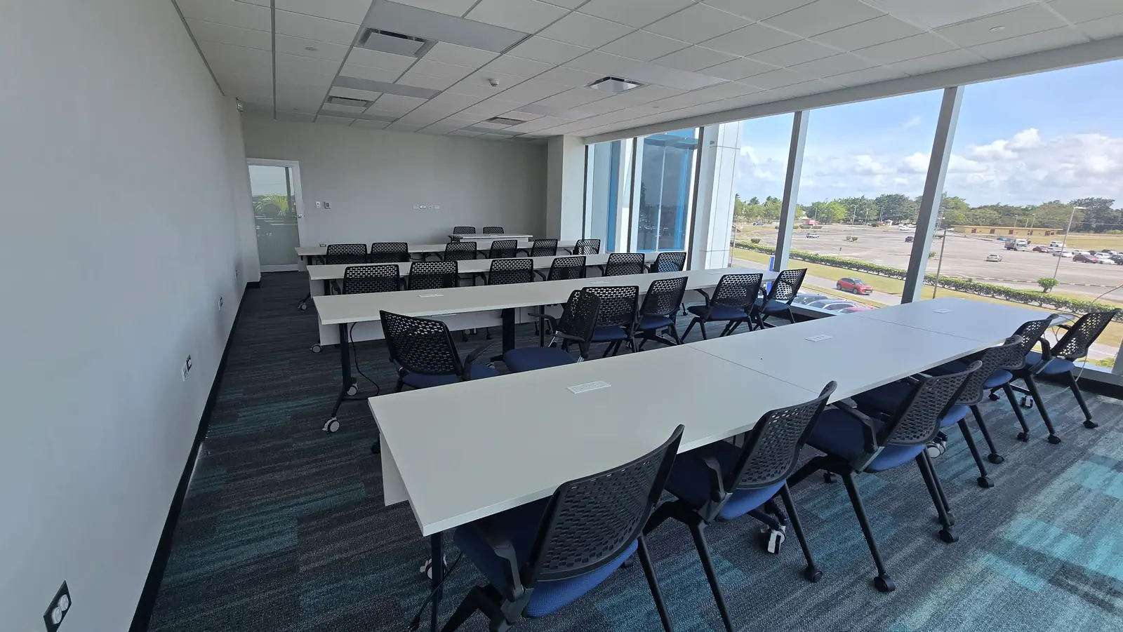 A training room with rows of desks and screens